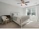 Bright bedroom featuring a stylish white metal bed frame, ceiling fan, and a charming writing desk at 108 Hillston Ln, Mooresville, NC 28115