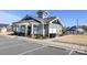 Attractive gray clubhouse near pool with ample parking, landscaping, and architectural roof details at 108 Hillston Ln, Mooresville, NC 28115