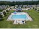 Aerial view of the community pool featuring a large swimming pool with umbrellas and lounge chairs at 108 Hillston Ln, Mooresville, NC 28115
