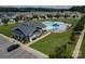 Exterior shot of the community pool with lounge chairs, umbrellas, and a clubhouse with grills at 108 Hillston Ln, Mooresville, NC 28115