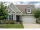 Charming home featuring a well-manicured lawn, inviting front porch, and a two-car garage at 108 Hillston Ln, Mooresville, NC 28115