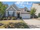 Charming home with grey siding, manicured lawn, and inviting entrance, offers curb appeal at 108 Hillston Ln, Mooresville, NC 28115