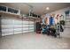 Organized two-car garage with overhead storage and epoxy flooring, providing ample space for vehicles and storage at 108 Hillston Ln, Mooresville, NC 28115