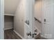Hallway shot showing coat hooks, storage, and stairs leading to upper level of home at 108 Hillston Ln, Mooresville, NC 28115