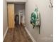 Hallway nook with wooden floors, an adjacent room, and convenient backpack hooks at 108 Hillston Ln, Mooresville, NC 28115