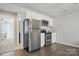 Compact kitchen featuring stainless steel appliances and white cabinets at 108 Hillston Ln, Mooresville, NC 28115