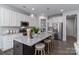 Open-concept kitchen features a large granite island with seating and modern stainless steel appliances at 108 Hillston Ln, Mooresville, NC 28115
