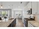 Open kitchen boasts stainless steel appliances, granite counters, and a seamless transition to the dining area at 108 Hillston Ln, Mooresville, NC 28115