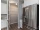 A stainless steel refrigerator is adjacent to a walk-in pantry with wire shelving at 108 Hillston Ln, Mooresville, NC 28115