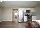 Efficient kitchen area with stainless steel appliances and white cabinetry, blending seamlessly into the living space at 108 Hillston Ln, Mooresville, NC 28115