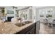 Bright kitchen featuring granite countertops, stainless steel appliances, and an open layout to the living area at 108 Hillston Ln, Mooresville, NC 28115