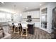 Open concept kitchen featuring an island with bar stool seating and granite countertops at 108 Hillston Ln, Mooresville, NC 28115