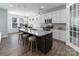Modern kitchen island with granite countertop and seating overlooks the dining area at 108 Hillston Ln, Mooresville, NC 28115