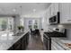 A stylish kitchen features granite counters, stainless steel appliances and an adjacent dining area at 108 Hillston Ln, Mooresville, NC 28115