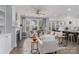 Bright living room featuring a fireplace, ceiling fan and a view to the dining and kitchen area at 108 Hillston Ln, Mooresville, NC 28115