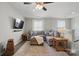 Bright upstairs living area with hardwood floors, large sectional sofa, and natural light at 108 Hillston Ln, Mooresville, NC 28115