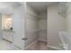 Spacious walk-in closet with wire shelving adjoins a bathroom with double granite vanity at 108 Hillston Ln, Mooresville, NC 28115