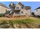Two story home featuring a deck, fenced yard, and established landscaping at 12025 Willingdon Rd, Huntersville, NC 28078