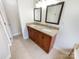Bathroom vanity featuring double sinks, granite countertops, and wood cabinets at 12025 Willingdon Rd, Huntersville, NC 28078