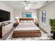 Bright bedroom featuring a wooden bed frame, soft white bedding, and neutral walls at 12025 Willingdon Rd, Huntersville, NC 28078
