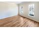 Bedroom featuring hardwood floors and neutral walls with two large windows offering natural light at 12025 Willingdon Rd, Huntersville, NC 28078