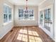 Dining area bathed in light, featuring hardwood floors and access to the deck via french doors at 12025 Willingdon Rd, Huntersville, NC 28078
