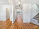 Hallway featuring hardwood floors, neutral walls, and staircase at 12025 Willingdon Rd, Huntersville, NC 28078