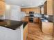 Well-equipped kitchen featuring wooden cabinets, granite countertops, and stainless steel appliances at 12025 Willingdon Rd, Huntersville, NC 28078