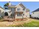 Spacious backyard featuring a deck and mature trees, offering a private outdoor space at 12025 Willingdon Rd, Huntersville, NC 28078