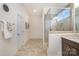 Elegant bathroom with tiled floors, glass-enclosed shower, and neutral colors create a serene and luxurious space at 1203 Kingsman Nw Ln, Concord, NC 28027