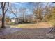 Open backyard with mature trees and sunny exposure at 1208 Fordham Rd, Charlotte, NC 28208