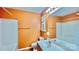 Cozy bathroom featuring a tub-shower combo, and a single sink with bright, orange walls at 12906 Sickles Dr, Charlotte, NC 28273