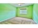 Bright bedroom with carpet, a ceiling fan, and vibrant green painted walls at 12906 Sickles Dr, Charlotte, NC 28273
