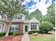 Charming townhome with a well-manicured lawn, featuring brick accents and lush greenery at 12906 Sickles Dr, Charlotte, NC 28273