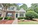Charming townhome with a well-manicured lawn, featuring brick accents and lush greenery at 12906 Sickles Dr, Charlotte, NC 28273
