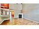 Bright living room with vaulted ceiling, fireplace, and stylish wood-look flooring at 12906 Sickles Dr, Charlotte, NC 28273