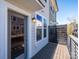 Outdoor balcony with wooden deck, metal railing, and views of surrounding neighborhood at 1311 Cerium Way, Charlotte, NC 28211