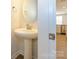 Elegant half-bathroom featuring pedestal sink, round mirror, and modern fixtures at 1311 Cerium Way, Charlotte, NC 28211
