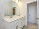Bathroom featuring a double sink vanity, white cabinets, and modern light fixture at 1311 Cerium Way, Charlotte, NC 28211