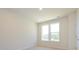 Bright bedroom featuring two windows offering outside views and neutral carpet at 1311 Cerium Way, Charlotte, NC 28211