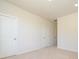 Neutral bedroom featuring white trim, neutral carpet, and several white doors at 1311 Cerium Way, Charlotte, NC 28211