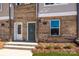 Close up of a townhome entryway with brick, steps, and door at 1311 Cerium Way, Charlotte, NC 28211