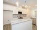 Well-lit kitchen with white cabinetry, stainless steel appliances, granite countertops, and a center island at 1311 Cerium Way, Charlotte, NC 28211