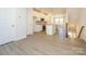 Open-concept kitchen features white cabinetry, stainless steel appliances and granite countertops at 1311 Cerium Way, Charlotte, NC 28211