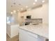 Bright kitchen featuring granite countertops, stainless steel appliances, an island and pendant lighting at 1311 Cerium Way, Charlotte, NC 28211
