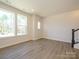 Bright living room featuring hardwood floors and large windows with lots of natural light at 1311 Cerium Way, Charlotte, NC 28211