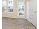 Bright living room with wood floors, natural light and a glass door at 1311 Cerium Way, Charlotte, NC 28211