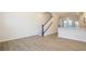 Open-concept living area showcasing hardwood floors, staircase, and kitchen with modern finishes at 1311 Cerium Way, Charlotte, NC 28211