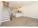 Spacious living room and modern kitchen with stainless steel appliances, granite countertops, and bright lighting at 1311 Cerium Way, Charlotte, NC 28211