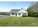 View of a well-kept one-story house with green shutters and a spacious lawn under a blue sky at 158 Angel Oaks Dr, Statesville, NC 28677